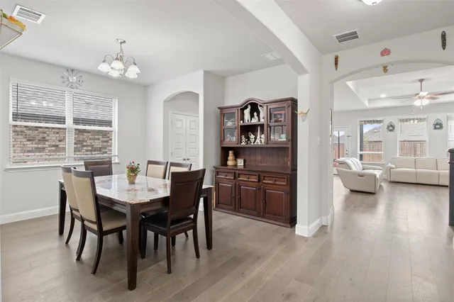 a view of a dining room with furniture and a chandelier