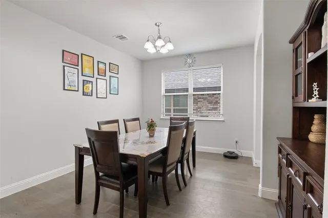 a view of a dining room with furniture and a chandelier