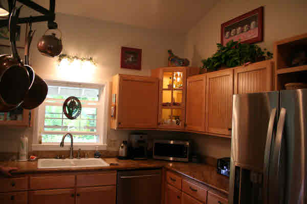 6668 Puupilo Road Kapaa, HI 96746 - Photo 11 of 23 a kitchen with a sink and a refrigerator