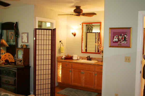 6668 Puupilo Road Kapaa, HI 96746 - Photo 13 of 23 a bathroom with a sink a mirror and a shower