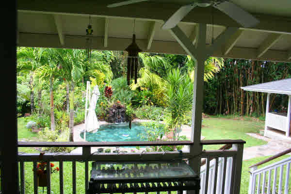 6668 Puupilo Road Kapaa, HI 96746 - Photo 19 of 23 a view of a patio with table and chairs under an umbrella