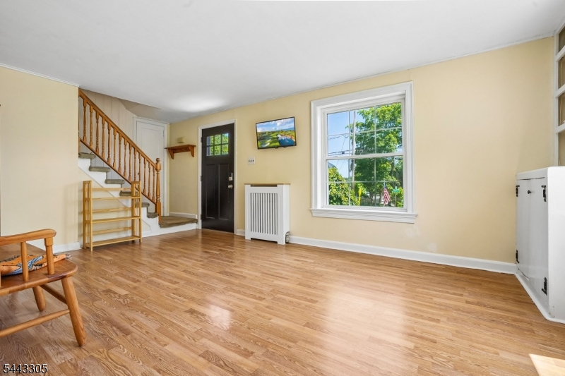 267 Kings Road Madison, NJ 07940 - Photo 3 of 37 a view of an empty room with wooden floor and a window