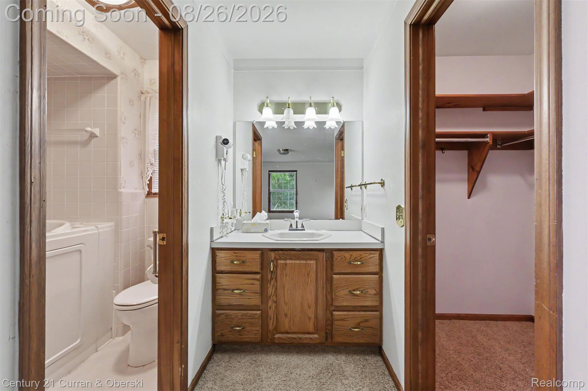 18227 Meridian Road Grosse Ile, MI 48138 - Photo 16 of 23 Wood-finish vanity with a white countertop and integrated sink