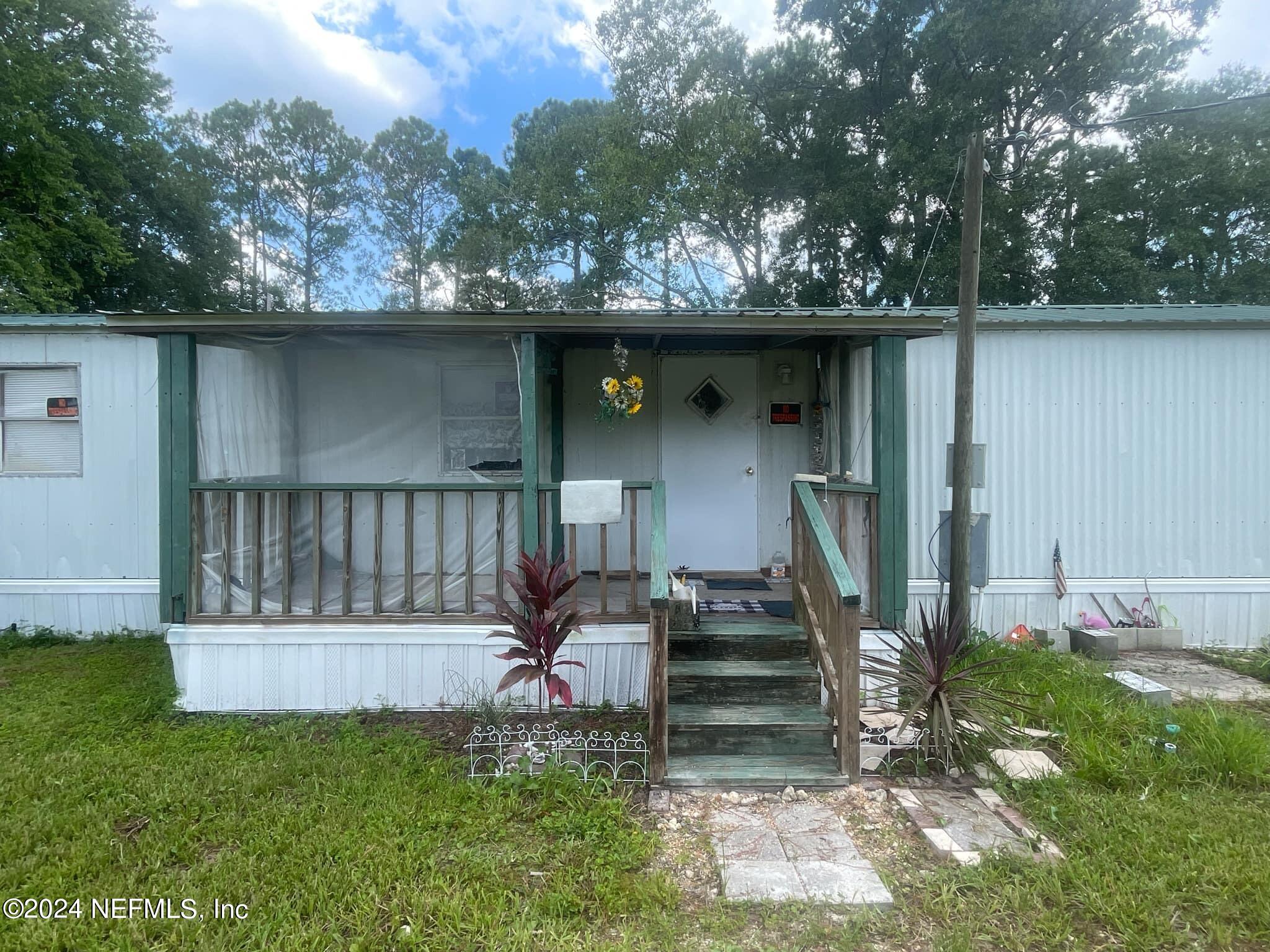 12550 Southeast 55th Place Starke, FL 32091 - Photo 1 of 29 a view of a wooden deck and a yard