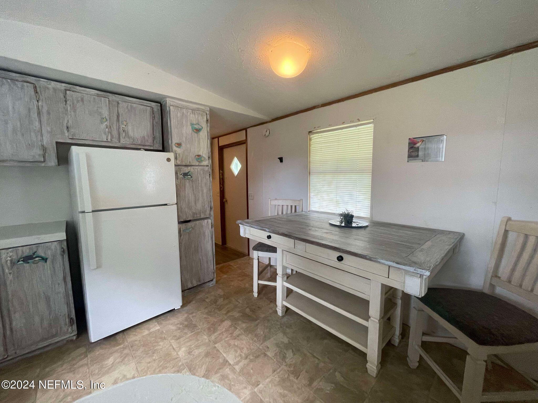 12550 Southeast 55th Place Starke, FL 32091 - Photo 12 of 29 a view of kitchen with stainless steel appliances granite countertop cabinets and a refrigerator
