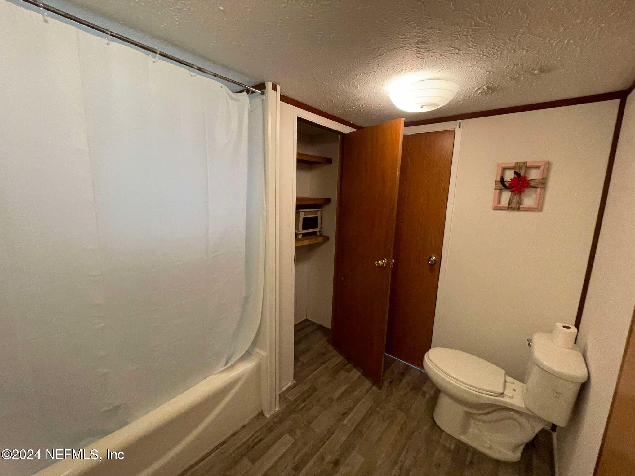 12550 Southeast 55th Place Starke, FL 32091 - Photo 14 of 29 a bathroom with a toilet and a shower