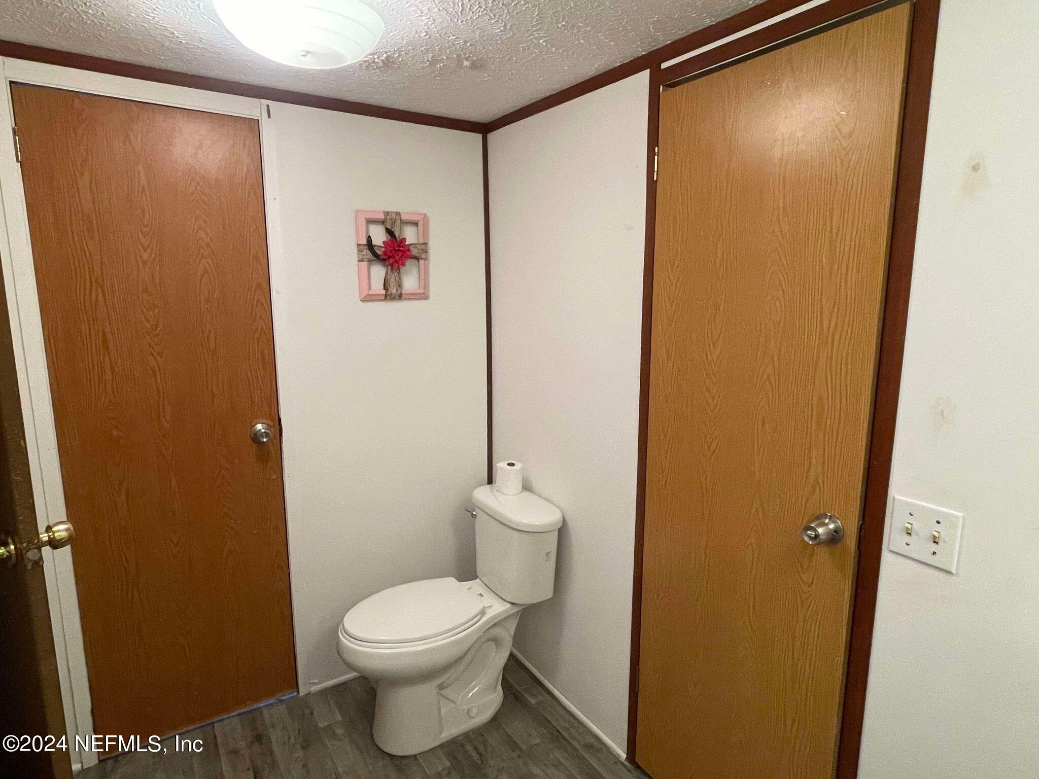 12550 Southeast 55th Place Starke, FL 32091 - Photo 15 of 29 a bathroom with a toilet and a shower