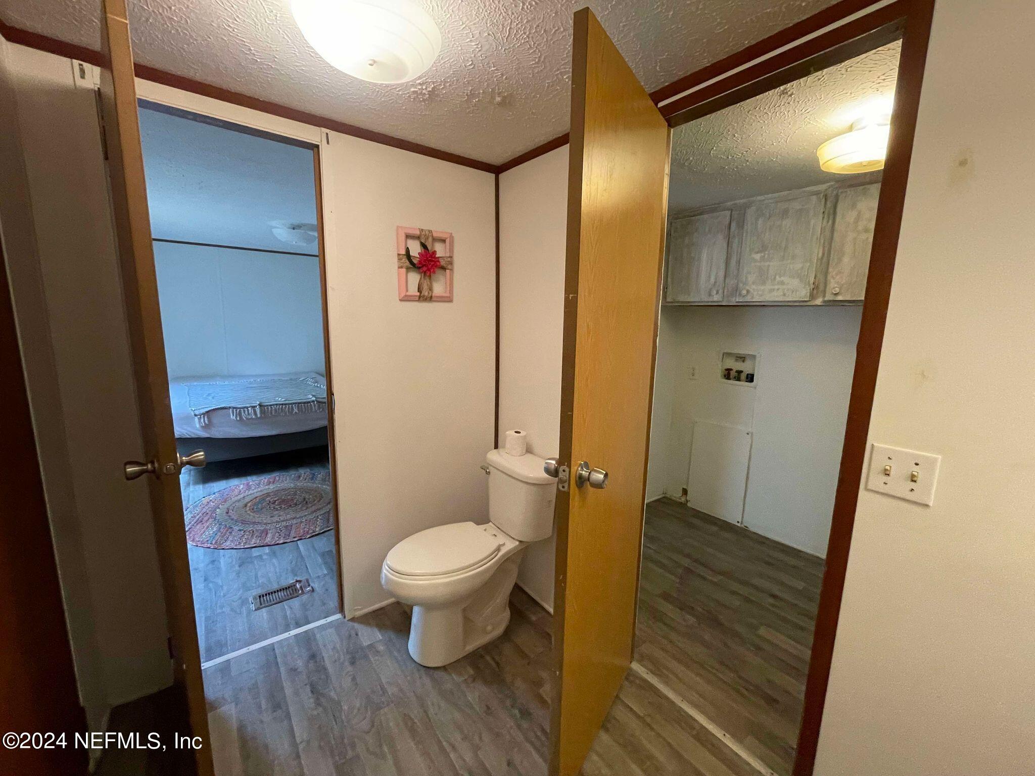 12550 Southeast 55th Place Starke, FL 32091 - Photo 16 of 29 a bathroom with a granite countertop sink toilet and shower