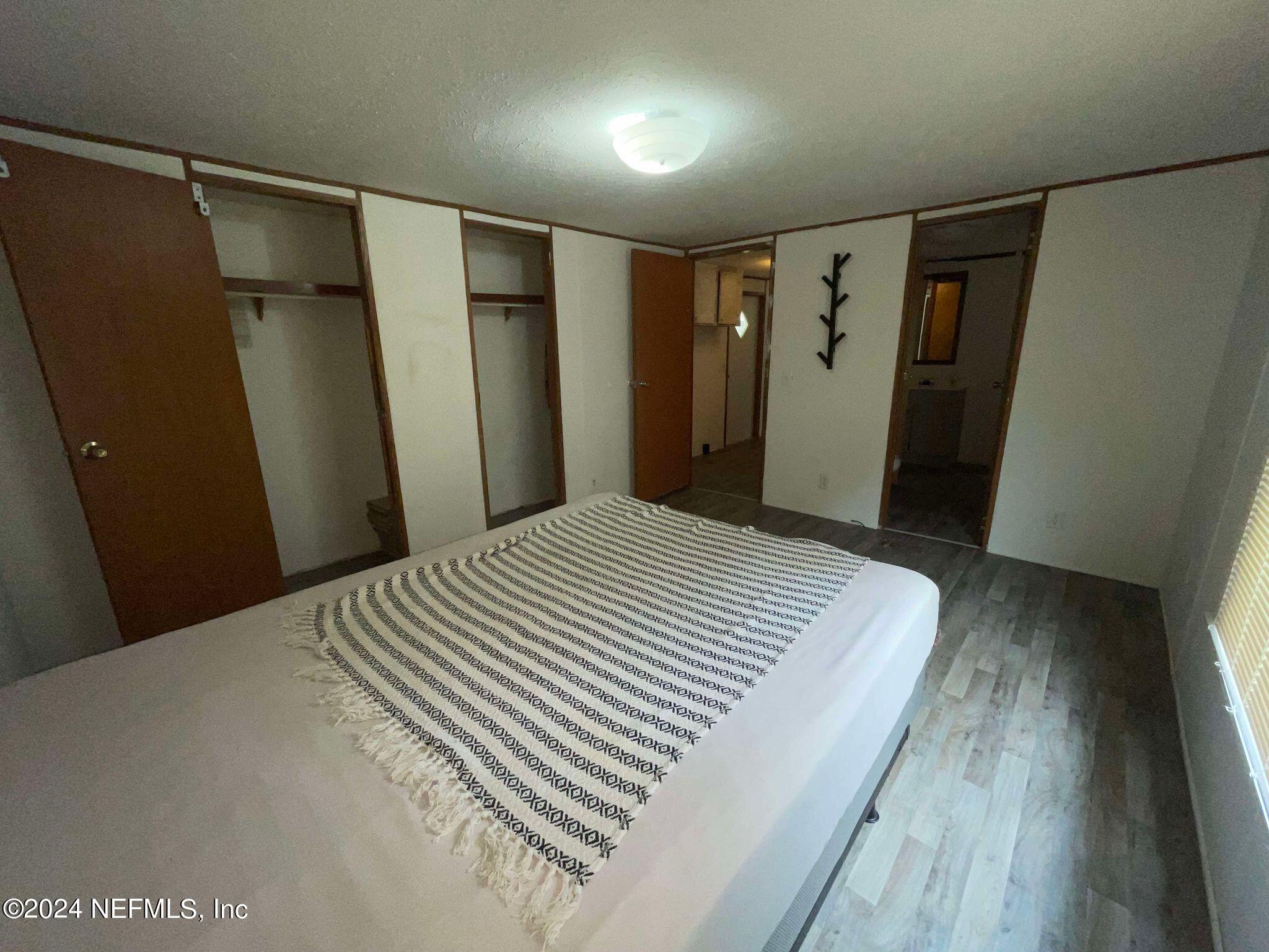 12550 Southeast 55th Place Starke, FL 32091 - Photo 19 of 29 a bedroom with a bed and a mirror