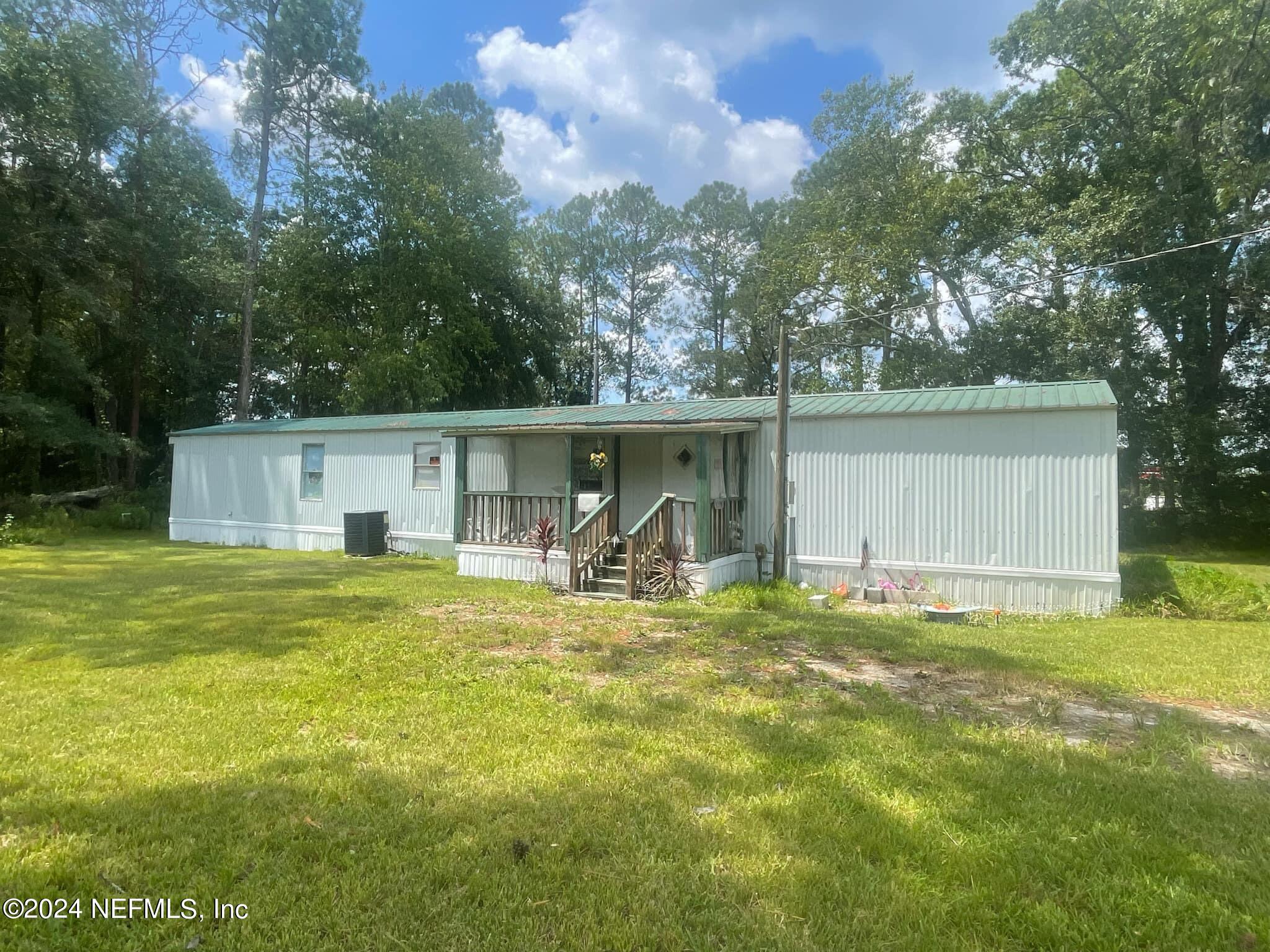 12550 Southeast 55th Place Starke, FL 32091 - Photo 2 of 29 a view of a house with backyard and sitting area
