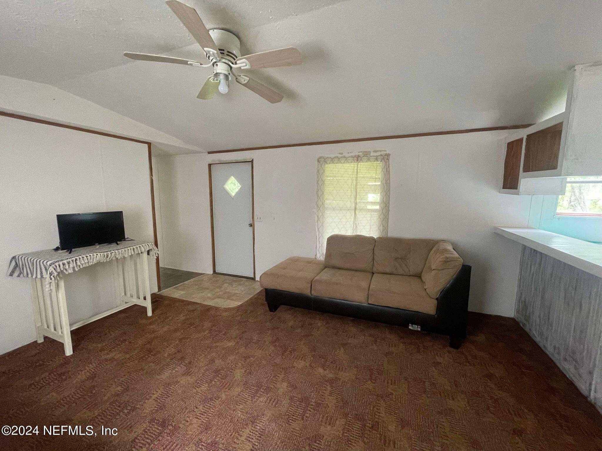 12550 Southeast 55th Place Starke, FL 32091 - Photo 21 of 29 a living room with furniture and a flat screen tv