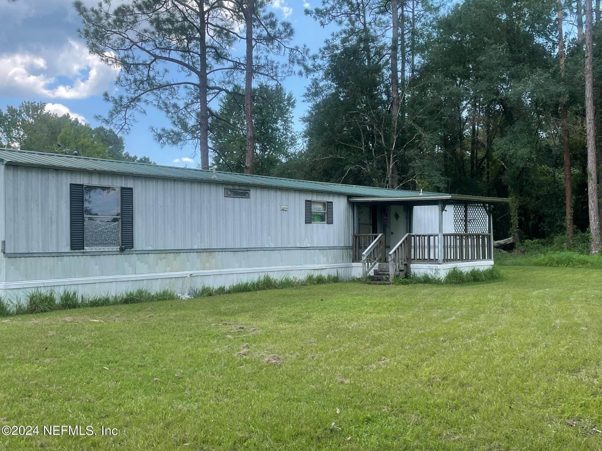 12550 Southeast 55th Place Starke, FL 32091 - Photo 29 of 29 a view of a house with a yard and sitting area