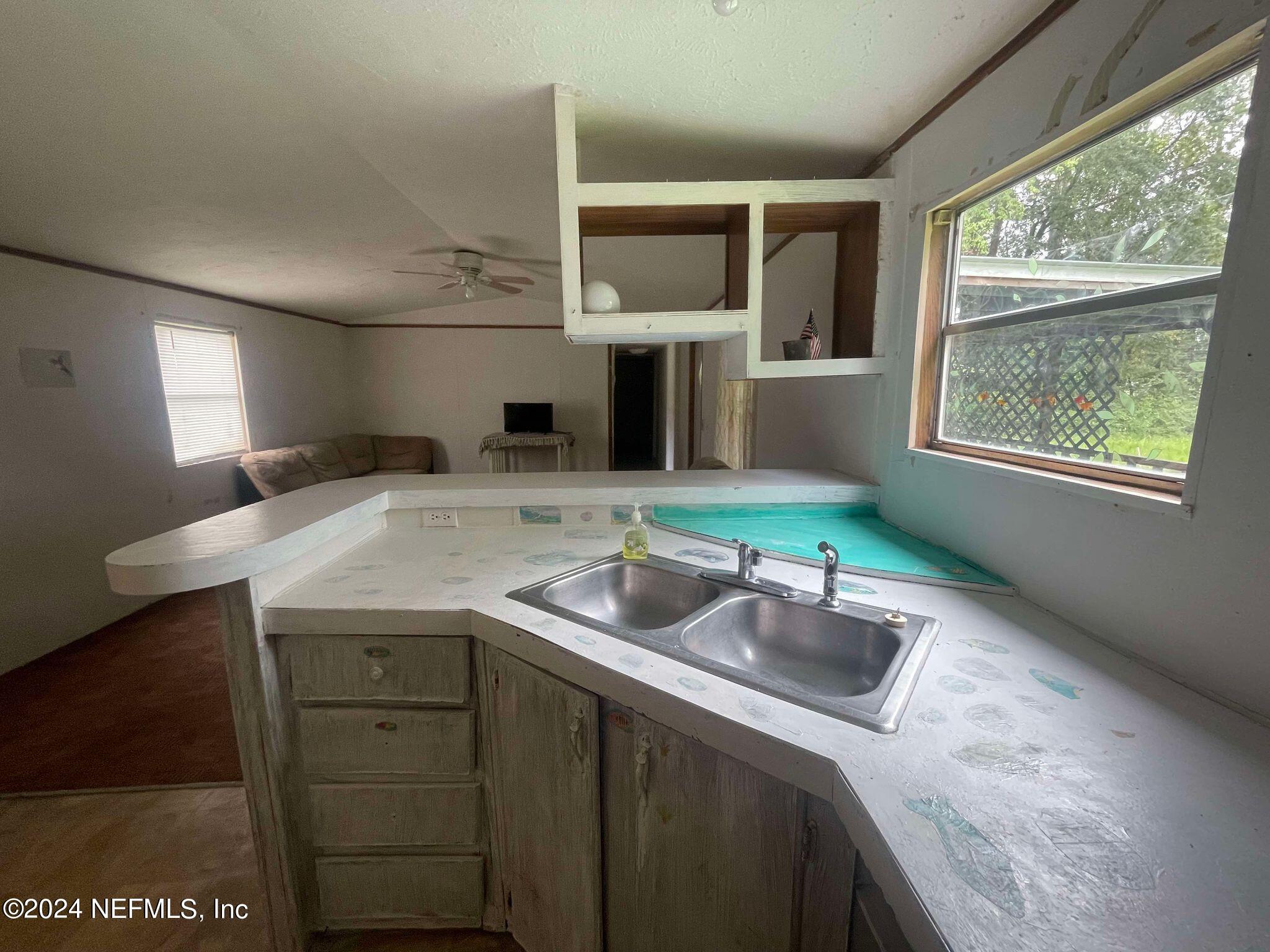 12550 Southeast 55th Place Starke, FL 32091 - Photo 10 of 29 a kitchen with a sink cabinets and window