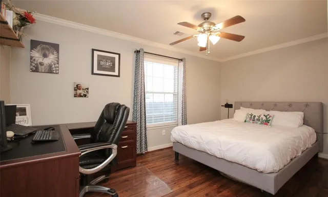 a bedroom with a bed and a desk