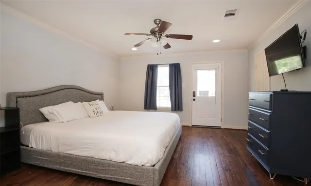 a bedroom with a bed and a flat screen tv