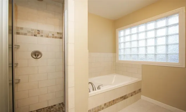 a bathroom with a tub and shower