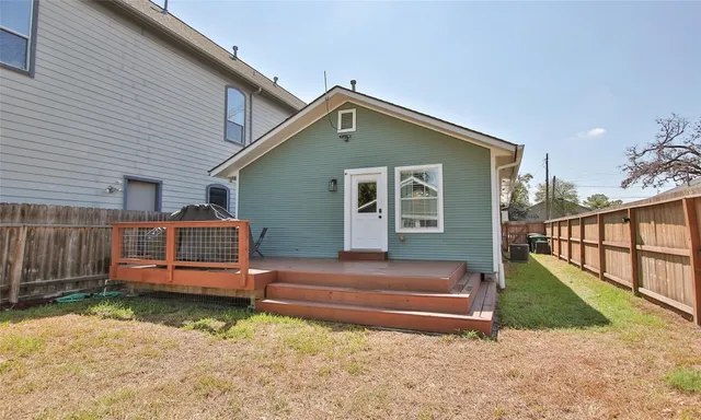 a view of backyard with a garden and deck
