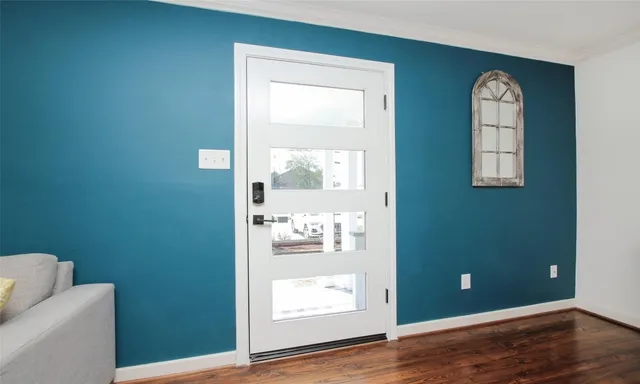 a view of an empty room and wooden floor