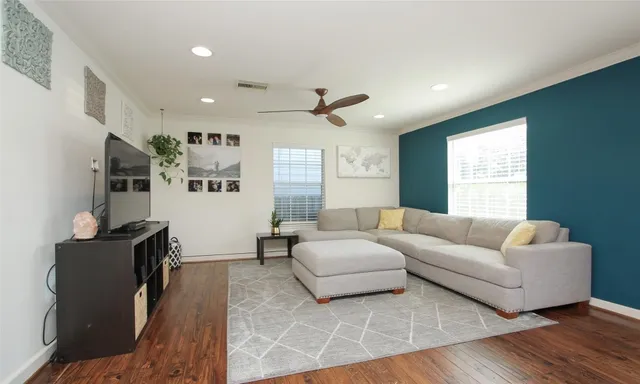 a living room with furniture ceiling fan and a window