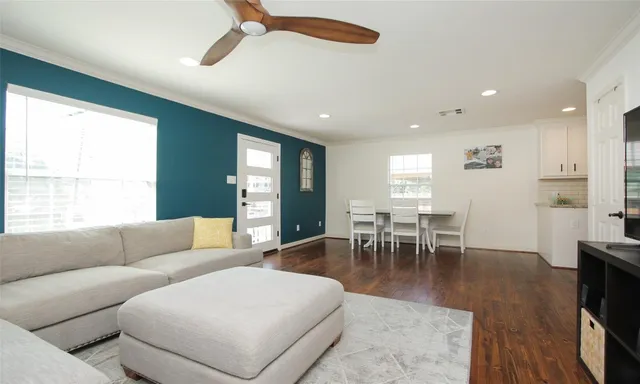 a living room with furniture a table and a large window