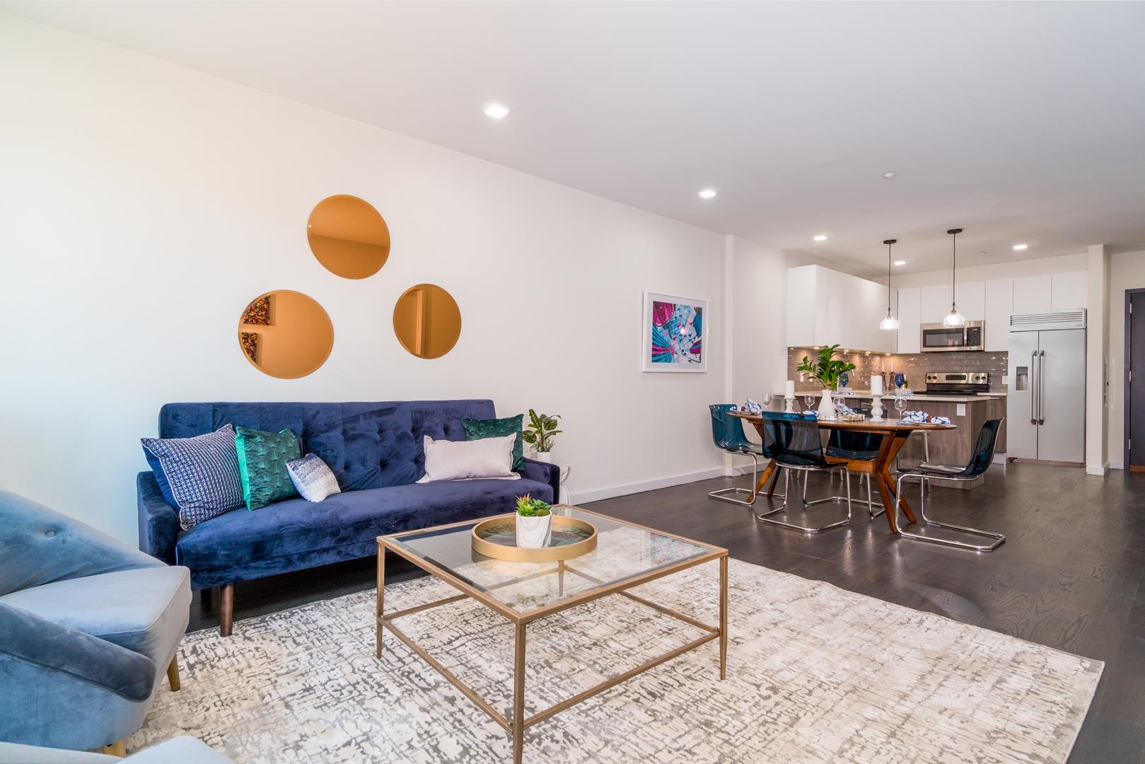 6122 Hudson Avenue, Unit 5A West New York, NJ 07093 - Photo 17 of 29 a living room with a couch and kitchen view with wooden floor