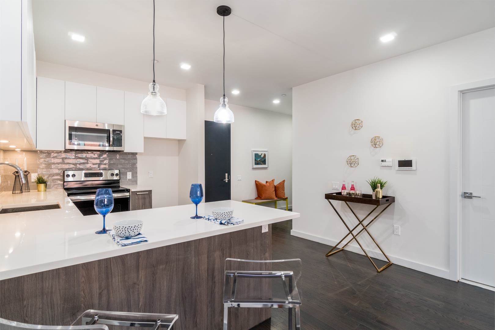 6122 Hudson Avenue, Unit 5A West New York, NJ 07093 - Photo 7 of 29 a kitchen with stainless steel appliances kitchen island granite countertop a sink a stove a dining table and chairs