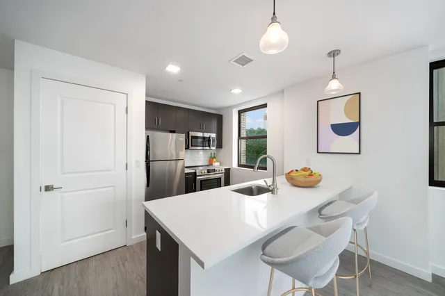 a kitchen with a table chairs and refrigerator
