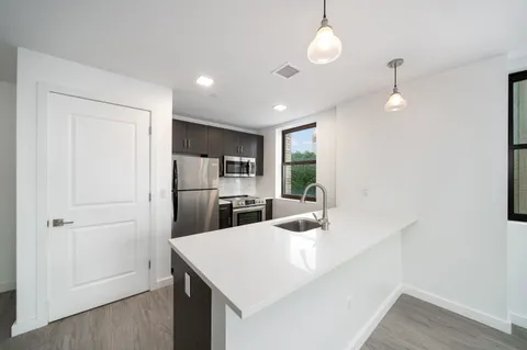 a kitchen with refrigerator and windows