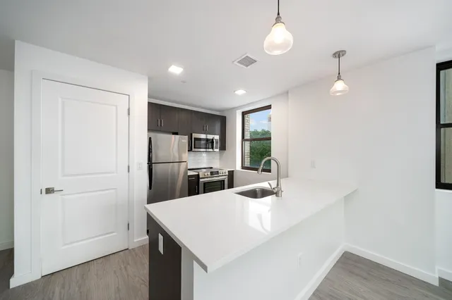 a kitchen with refrigerator and windows