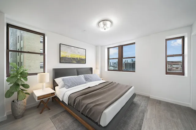 a bedroom with a bed and a painting on the wall