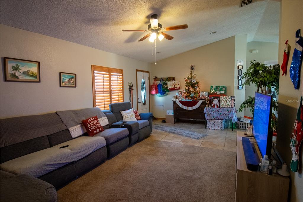 6219 Coliseum Boulevard Port Charlotte, FL 33981 - Photo 11 of 48 a living room with furniture and a flat screen tv