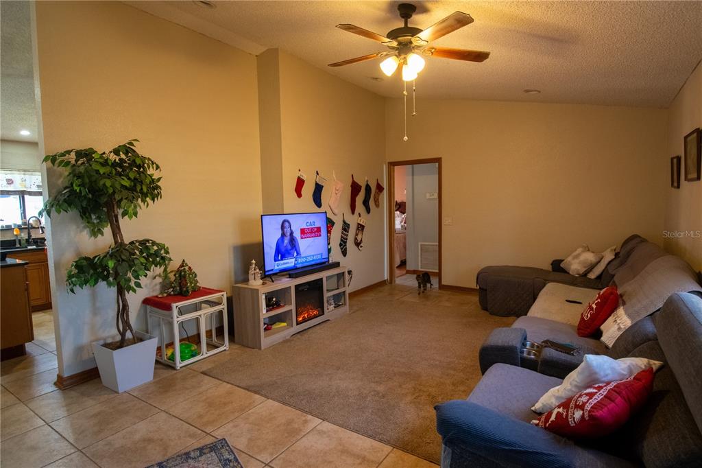 6219 Coliseum Boulevard Port Charlotte, FL 33981 - Photo 12 of 48 a living room with furniture and a flat screen tv