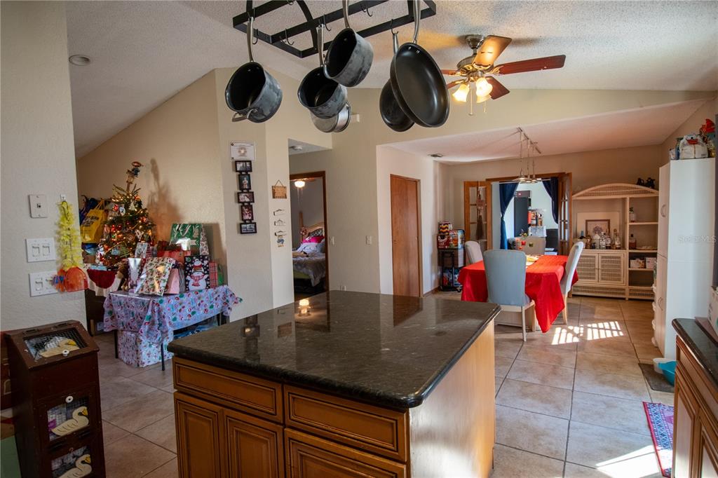6219 Coliseum Boulevard Port Charlotte, FL 33981 - Photo 16 of 48 a view of a dining room with furniture and a kitchen