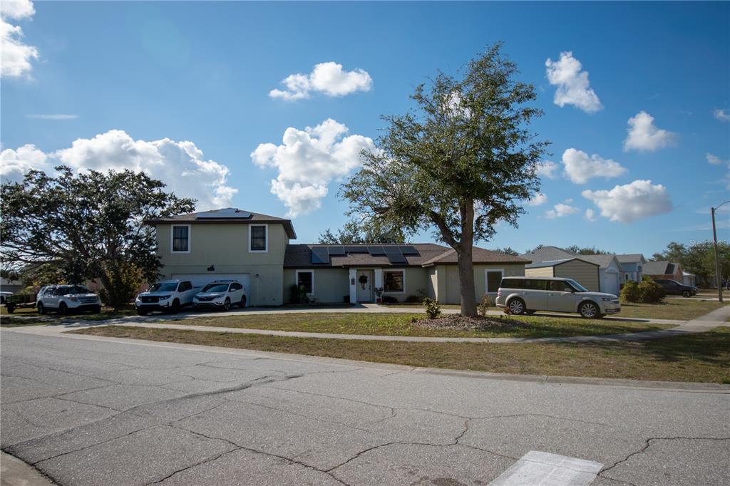 6219 Coliseum Boulevard Port Charlotte, FL 33981 - Photo 2 of 48 a front view of a house with lots of trees and cars