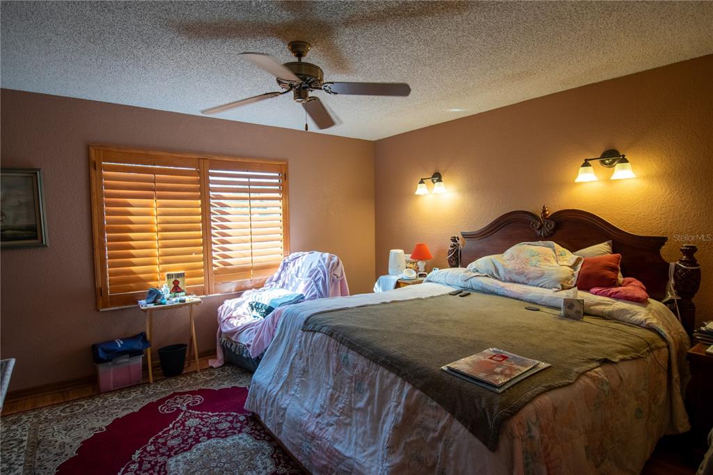 6219 Coliseum Boulevard Port Charlotte, FL 33981 - Photo 21 of 48 a bedroom with a bed and a lamp