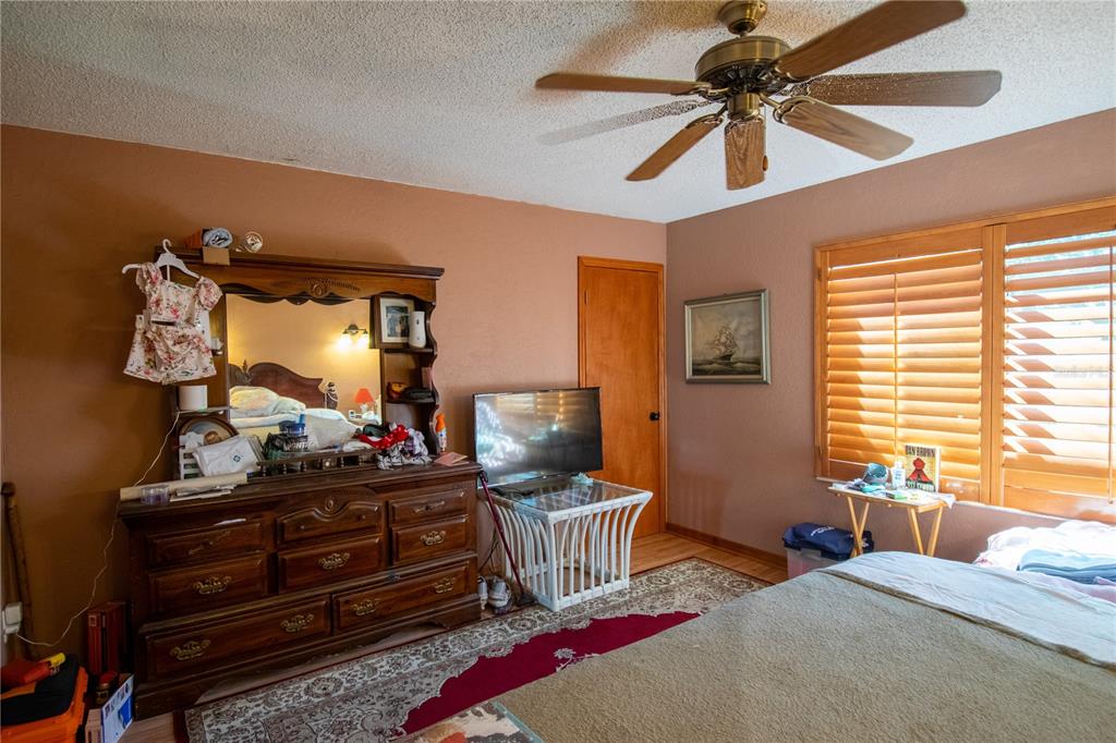6219 Coliseum Boulevard Port Charlotte, FL 33981 - Photo 22 of 48 a bedroom with a bed and a mirror on the dresser