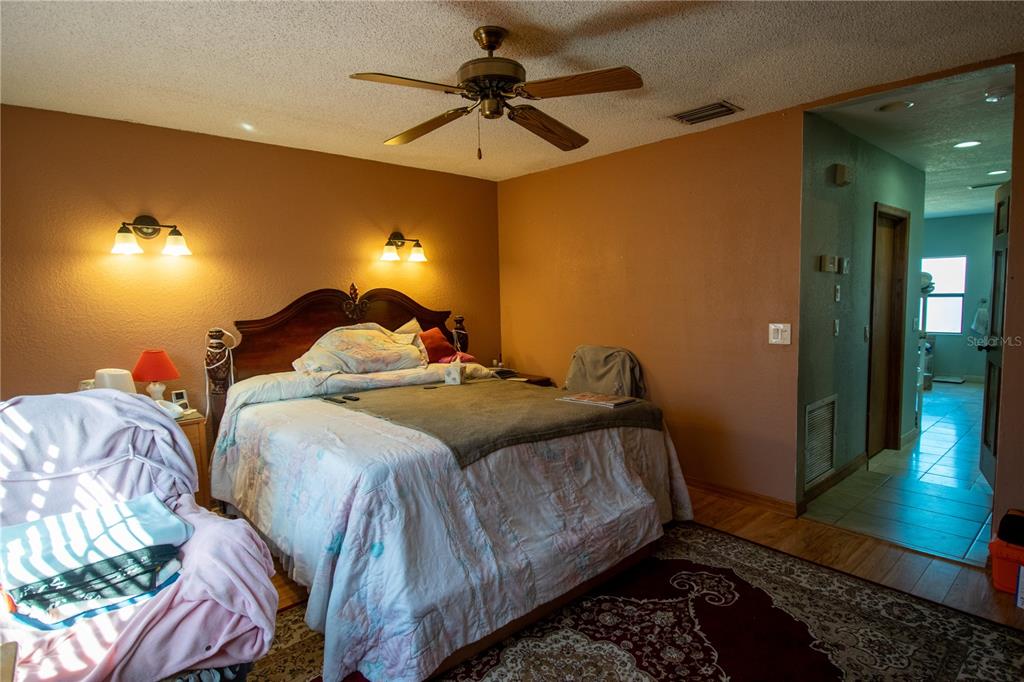6219 Coliseum Boulevard Port Charlotte, FL 33981 - Photo 23 of 48 a bedroom with a bed and a chandelier