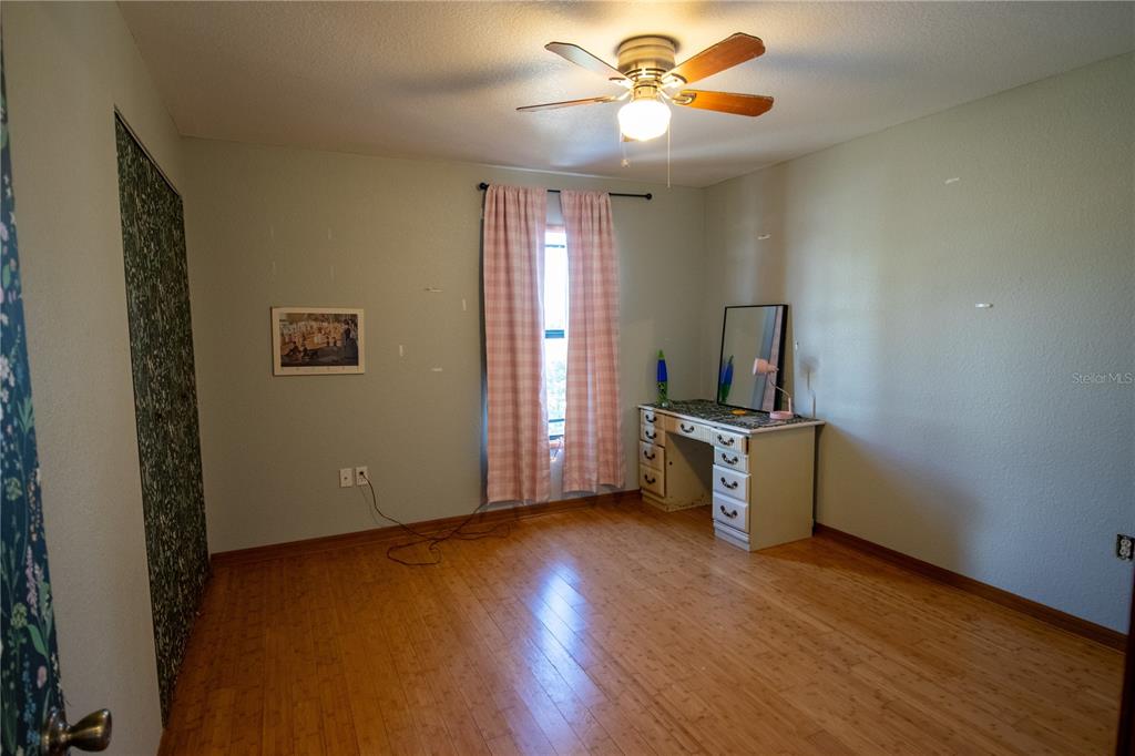 6219 Coliseum Boulevard Port Charlotte, FL 33981 - Photo 30 of 48 a view of workspace with wooden floor and window