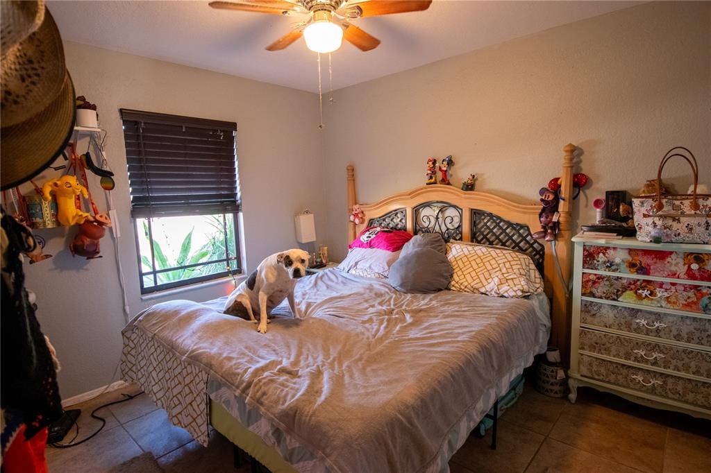 6219 Coliseum Boulevard Port Charlotte, FL 33981 - Photo 32 of 48 a bedroom with a bed and a chandelier