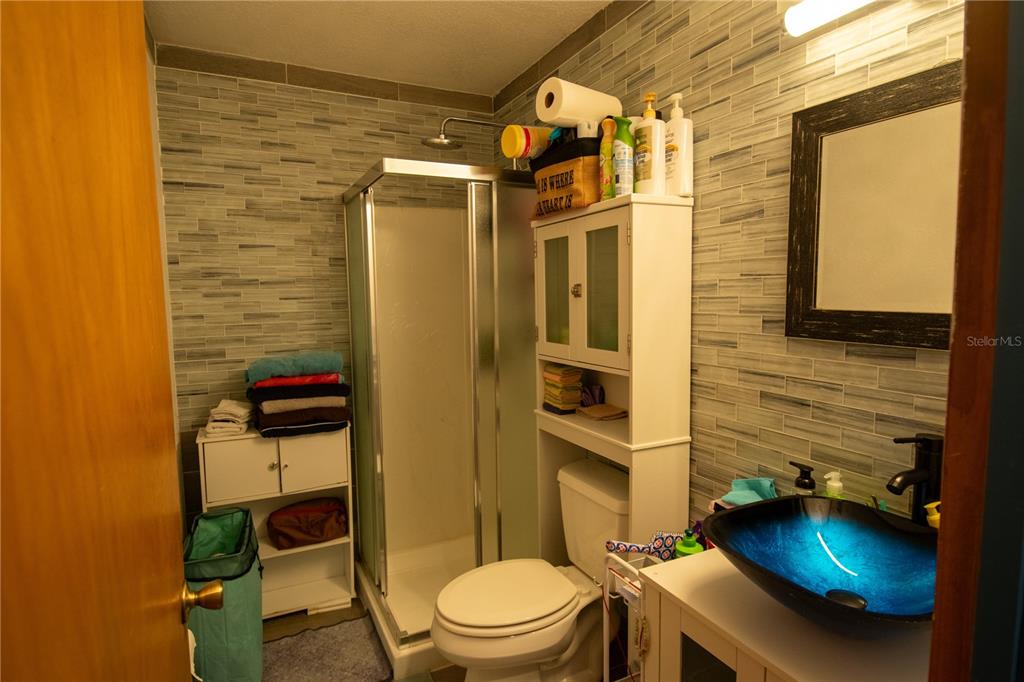 6219 Coliseum Boulevard Port Charlotte, FL 33981 - Photo 34 of 48 a bathroom with a toilet and a shower