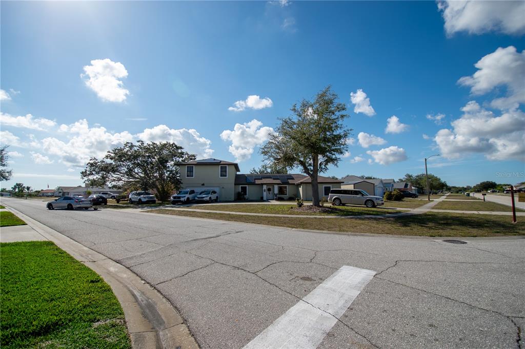 6219 Coliseum Boulevard Port Charlotte, FL 33981 - Photo 43 of 48 a view of a house with a yard and a garage
