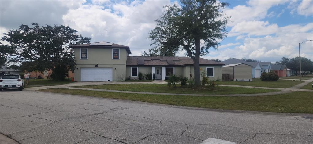 6219 Coliseum Boulevard Port Charlotte, FL 33981 - Photo 44 of 48 a front view of a house with a yard and trees