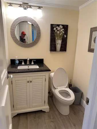 a bathroom with a toilet a sink and a mirror