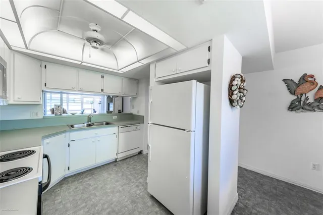 a kitchen with a refrigerator and a sink