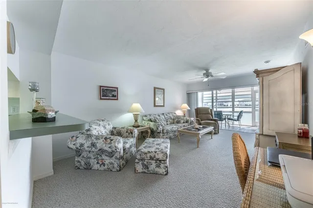 a bedroom with a bed next to a window and a chandelier