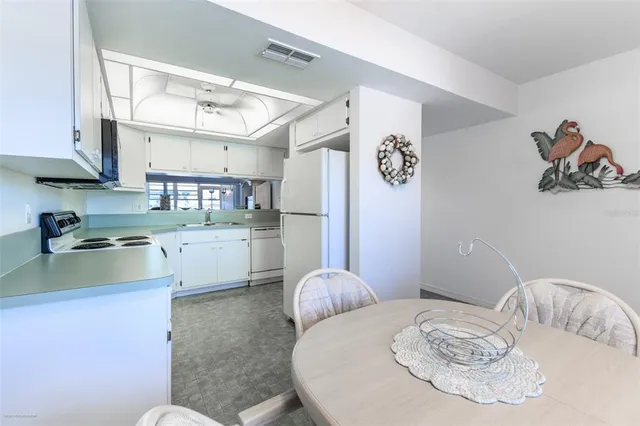 a kitchen with refrigerator and stove