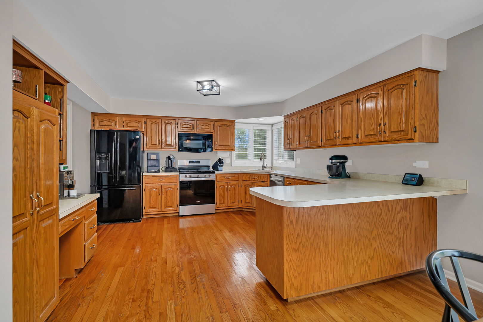 6 West Wend Street Lemont, IL 60439 - Photo 11 of 31 a kitchen with stainless steel appliances a stove a sink a refrigerator white cabinets and wooden floor