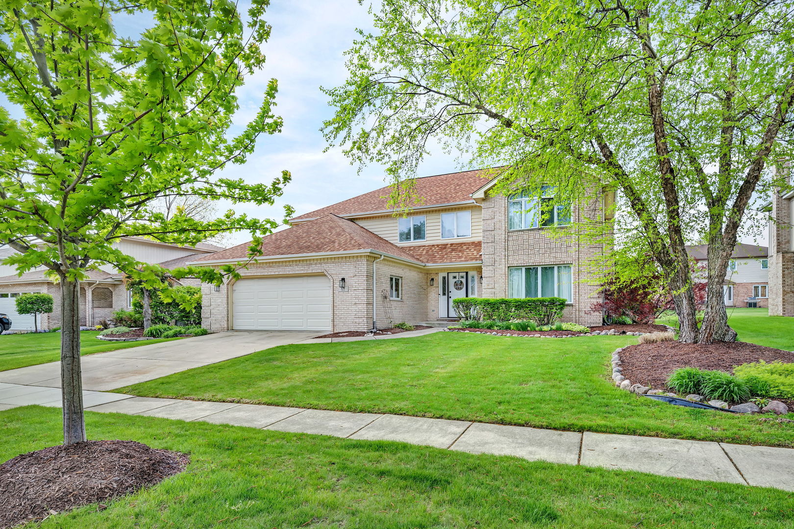 6 West Wend Street Lemont, IL 60439 - Photo 2 of 31 a view of a house next to a big yard and large trees
