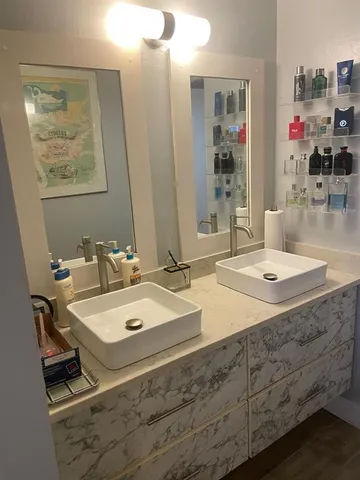 a bathroom with a sink a mirror and a shower