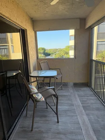 a living room with chairs and a flat screen tv